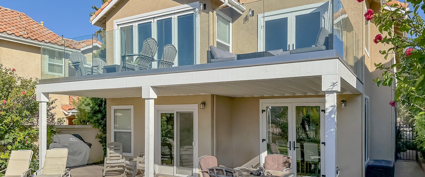 Exterior view of Dana Point residence's newly extended deck and new French doors on the first and second levels.