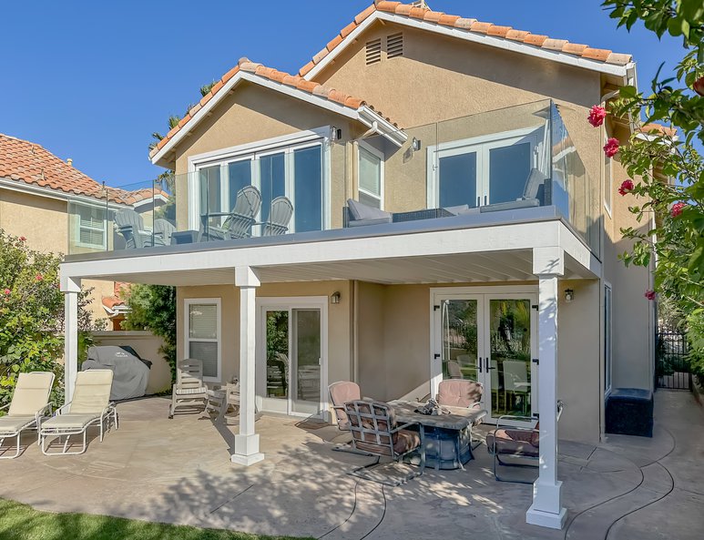 Exterior view of Dana Point residence's newly extended deck and new French doors on the first and second levels.